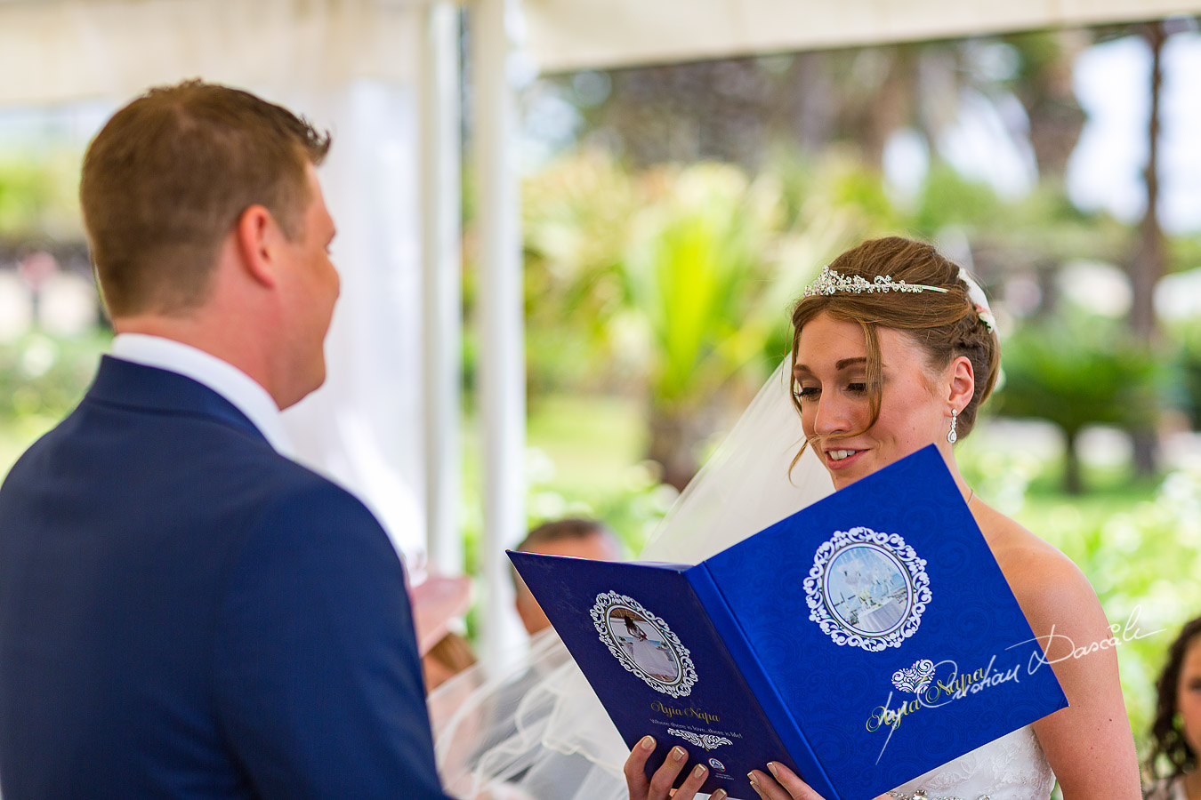 Alicia reading her vows, moment photographed at Nissi Beach Resort in Ayia Napa, Cyprus by Cristian Dascalu.