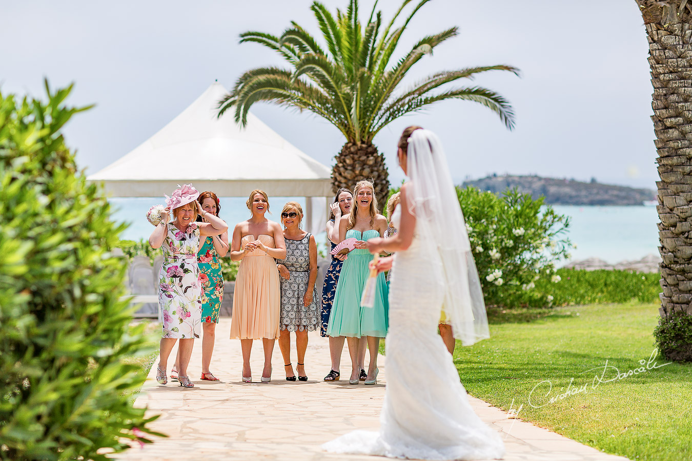 Alicia tossing the bouquet, moment photographed at Nissi Beach Resort in Ayia Napa, Cyprus by Cristian Dascalu.