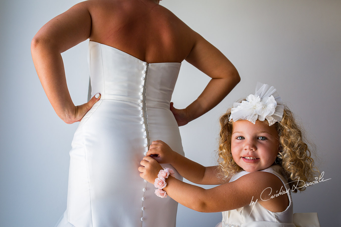 Little Eva helping her mother to tie up the wedding dress.