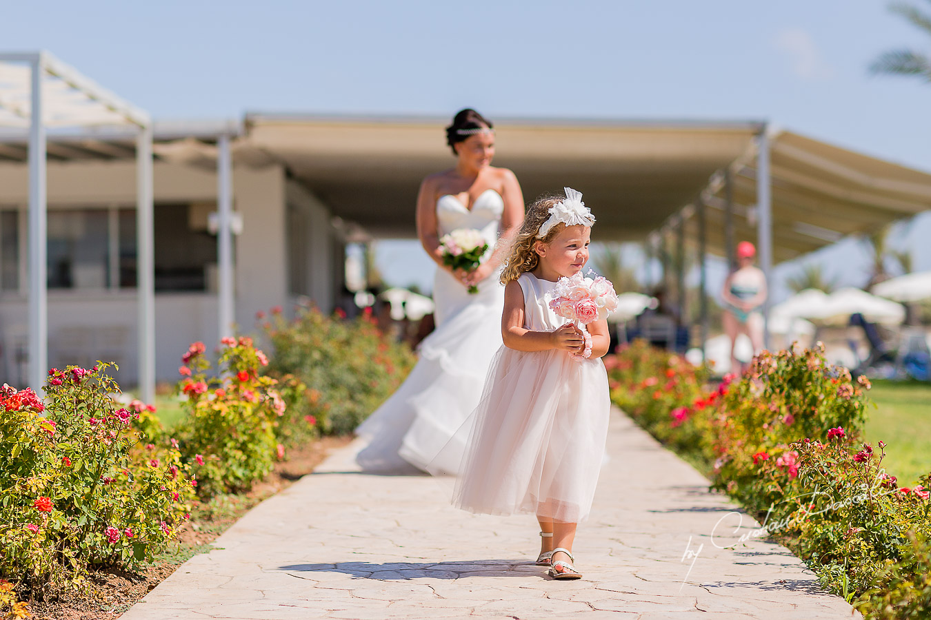 Eva, the flower girl and Amy, the bride, arriving at the wedding ceremony at King Elvelton Hotel and Resort in Paphos, Cyprus.