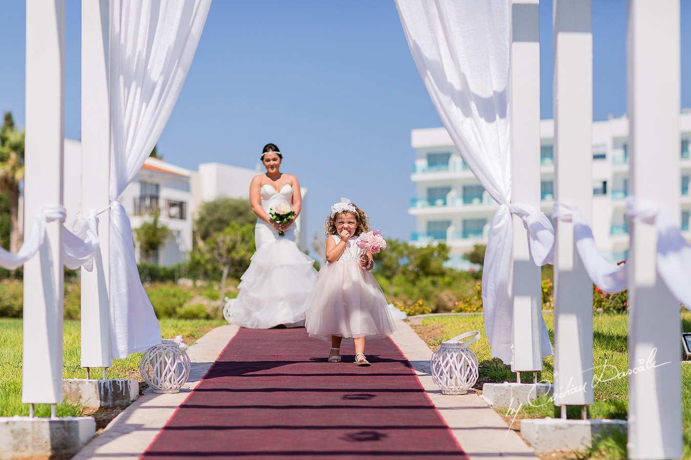 Eva, the flower girl and Amy, the bride, arriving at the wedding ceremony at King Elvelton Hotel and Resort in Paphos, Cyprus.