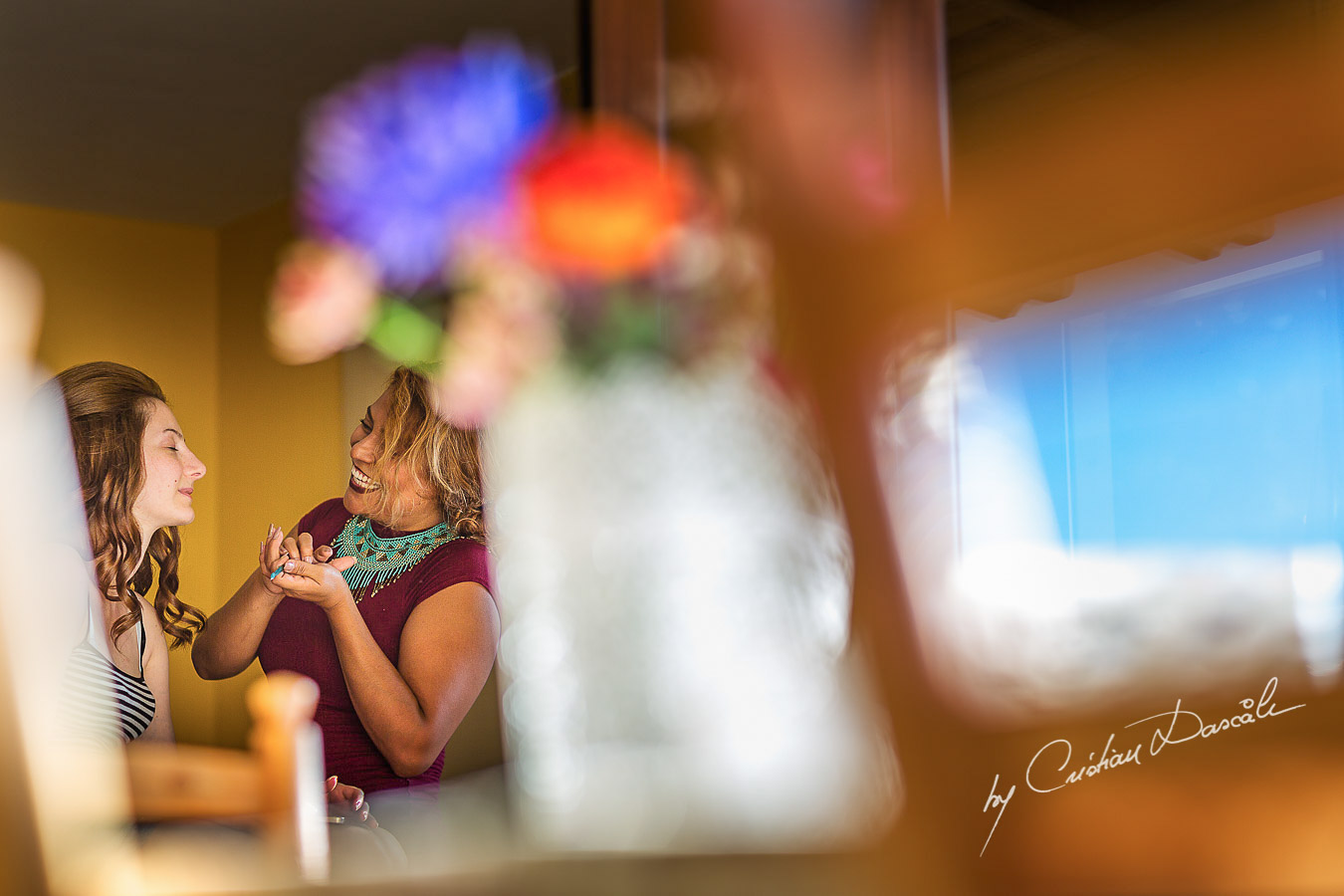 Best friend applying makeup for bride at the Roses Vila in Trimiklini, Cyprus.