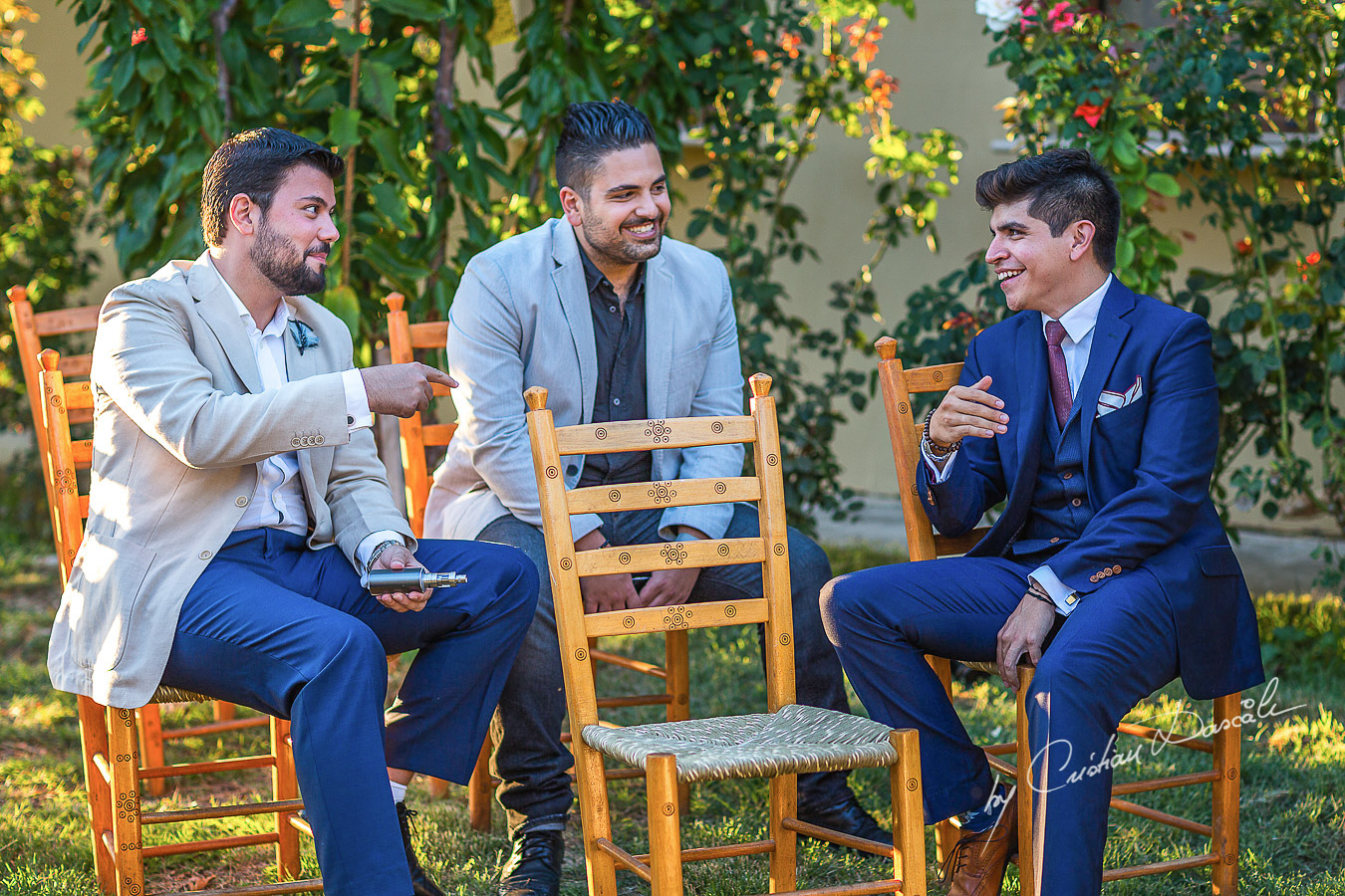 Guests laughing with the groom at a beautiful bohemian wedding in Trimiklini.