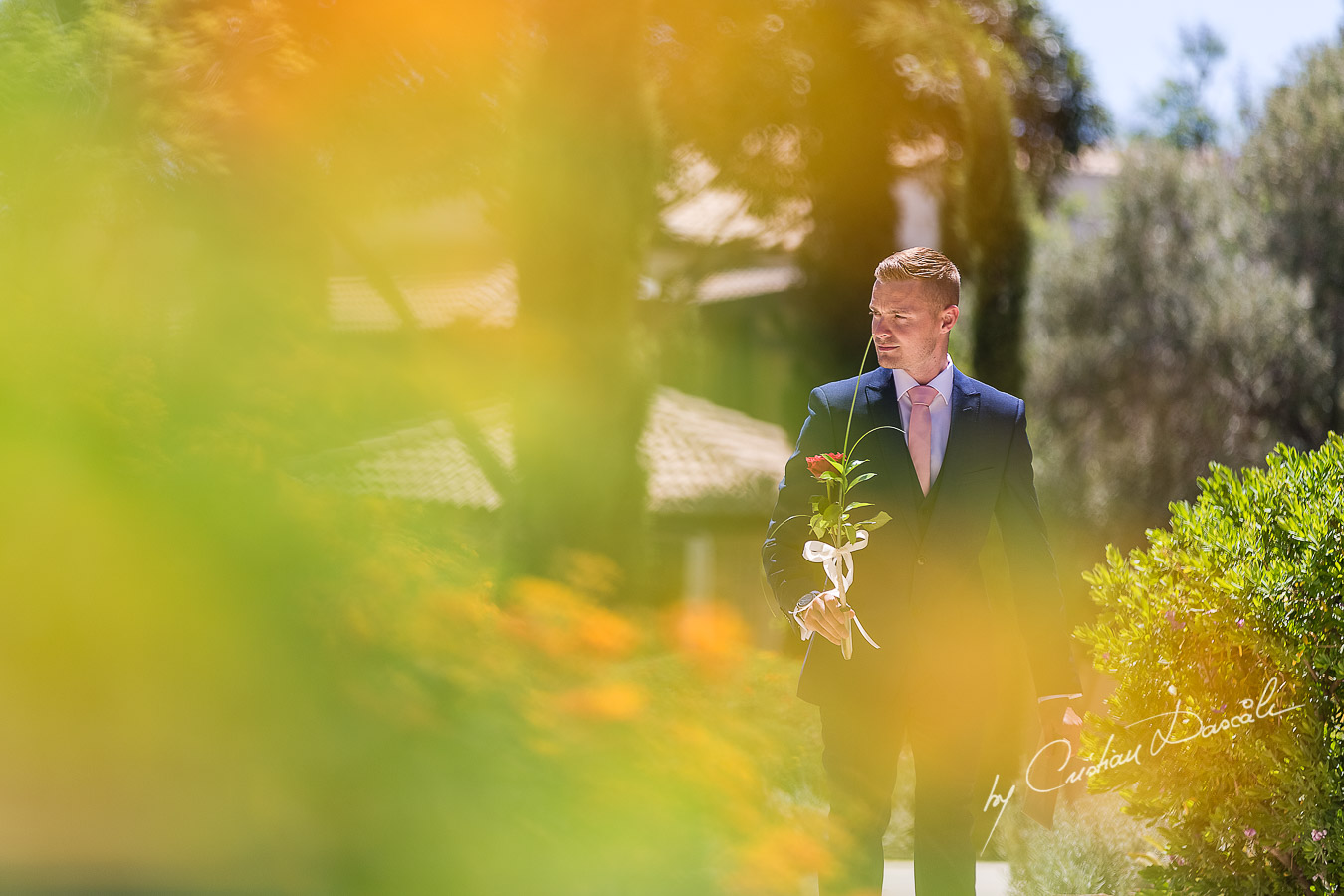 The Bestman delivering a flower and an envelop captured at Aphrodite Hills Resort before the wedding ceremony by Cristian Dascalu.