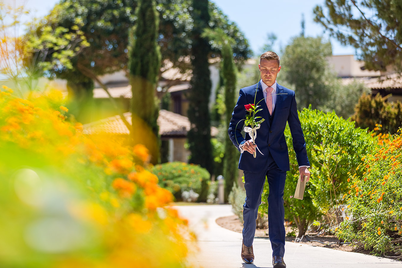 The Bestman delivering a flower and an envelop captured at Aphrodite Hills Resort before the wedding ceremony by Cristian Dascalu.