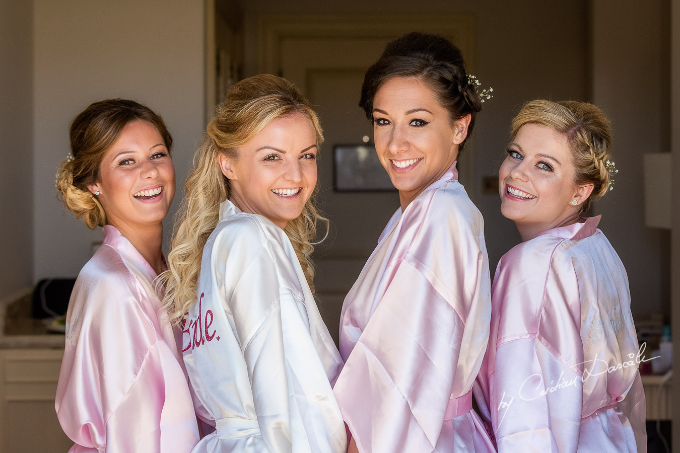 Team Bride is being photographed in the Bridal robe before getting ready at Aphrodite Hills Resort by wedding photographer Cristian Dascalu.