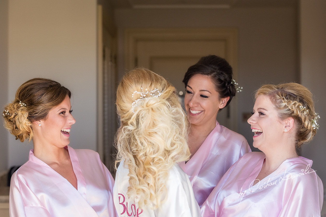 Team Bride is being photographed in the Bridal robe before getting ready at Aphrodite Hills Resort by wedding photographer Cristian Dascalu.