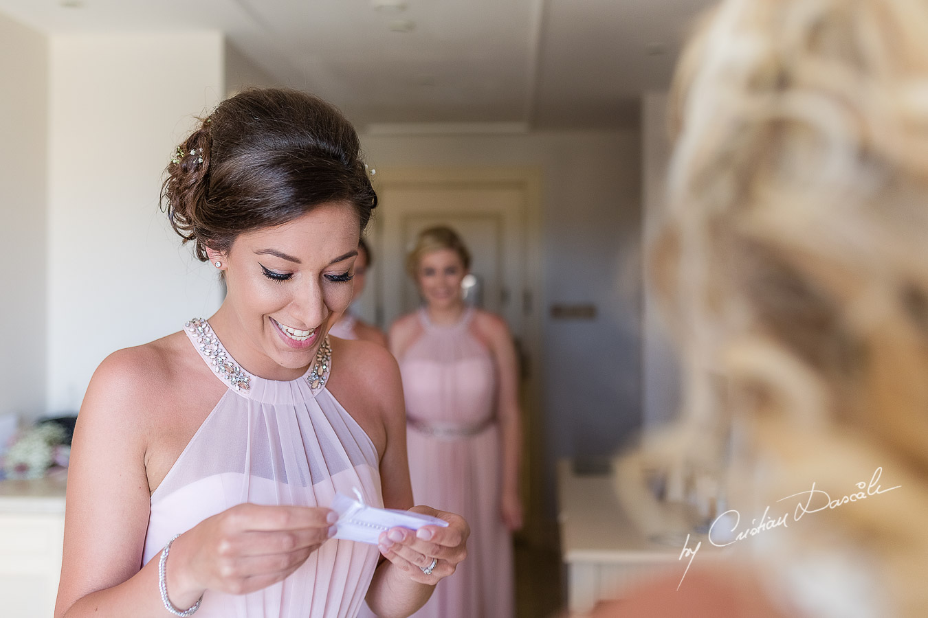 Emotional moment between the bride and maid of honor captured during a wedding at Aphrodite Hills Resort in Cyprus by Cyprus Photographer Cristian Dascalu.
