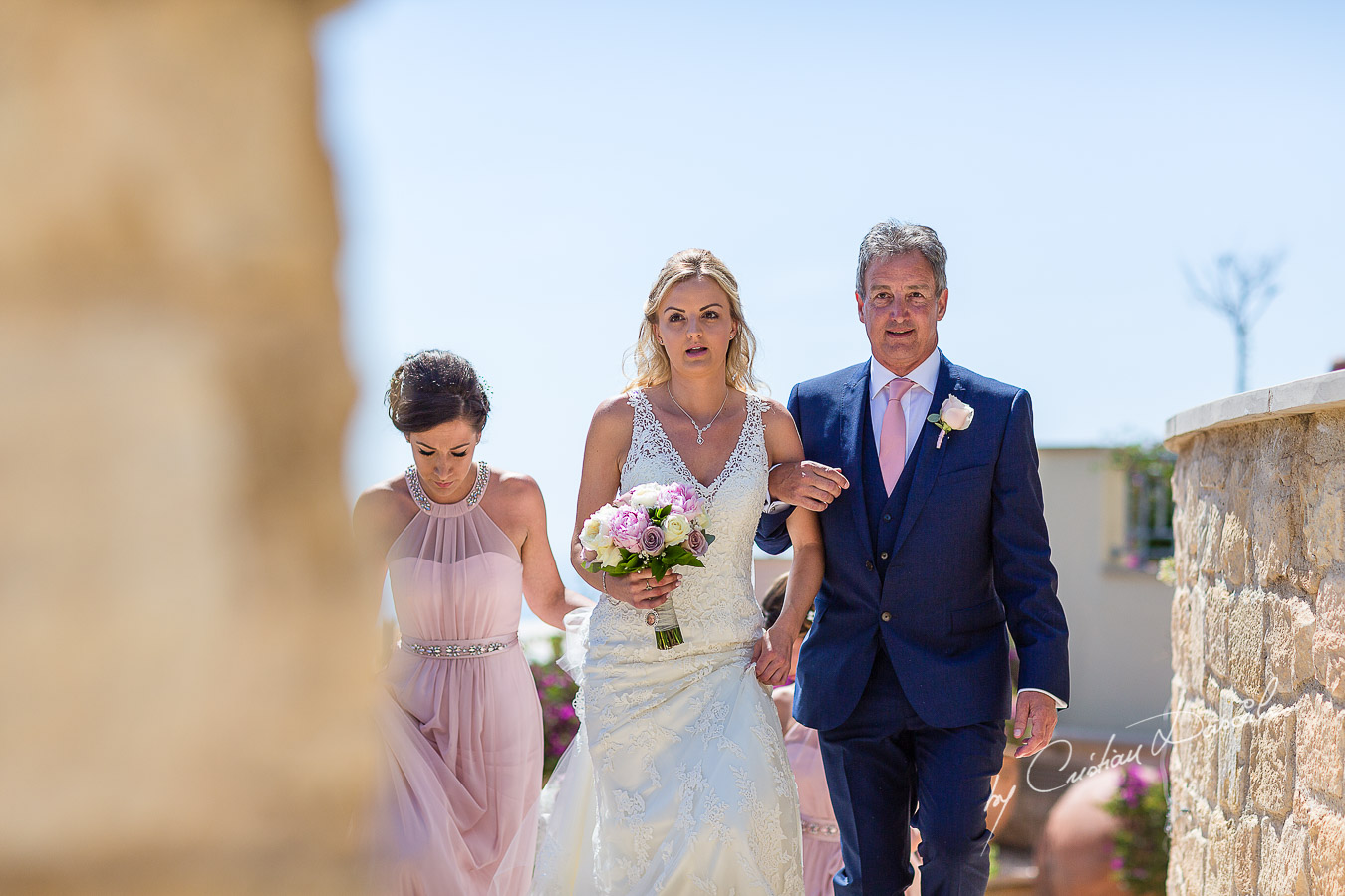 The moment when the bride arrives at the wedding ceremony at Aphrodite Hills Resort in Cyprus, captured by photographer Cristian Dascalu.