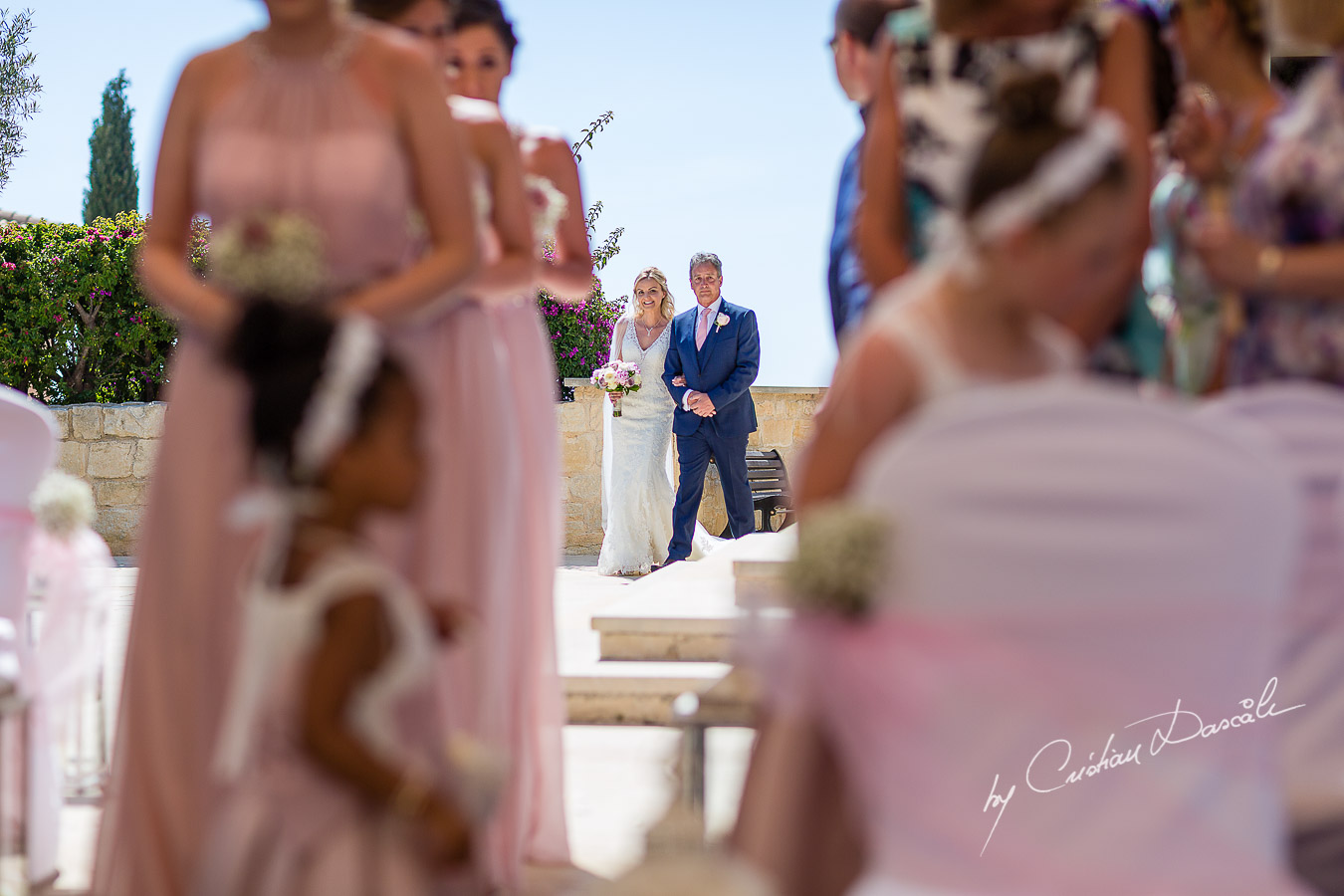 The moment when the bride arrives at the wedding ceremony at Aphrodite Hills Resort in Cyprus, captured by photographer Cristian Dascalu.