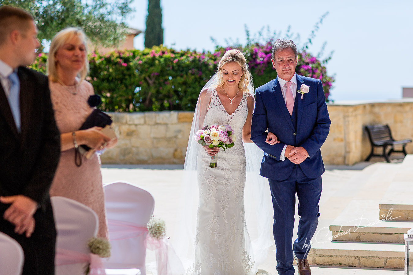 The moment when the bride arrives at the wedding ceremony at Aphrodite Hills Resort in Cyprus, captured by photographer Cristian Dascalu.