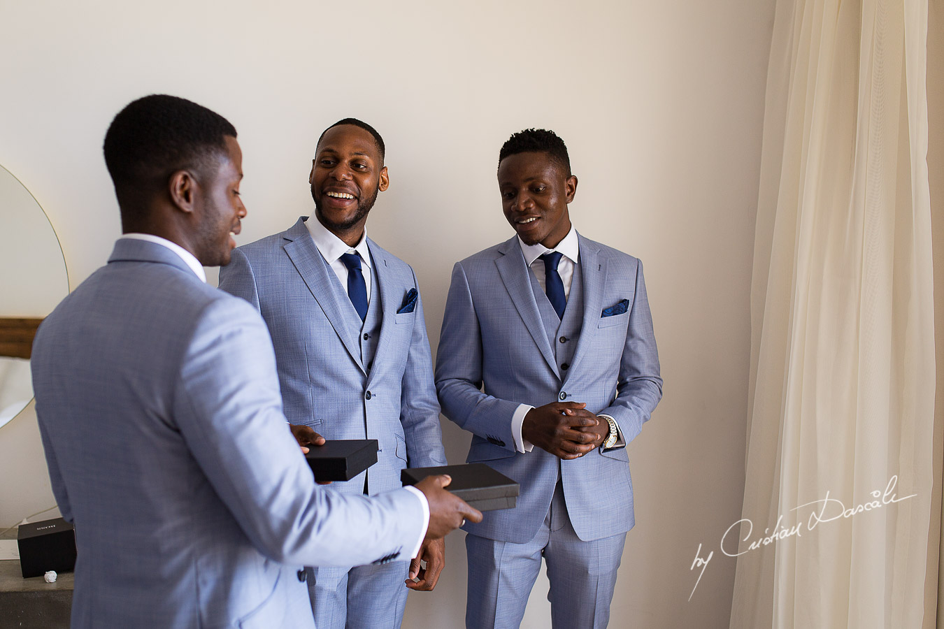 Moments when the groom is giving gifts to his best men captured at a wedding at Minthis Hills in Cyprus, by Cristian Dascalu.