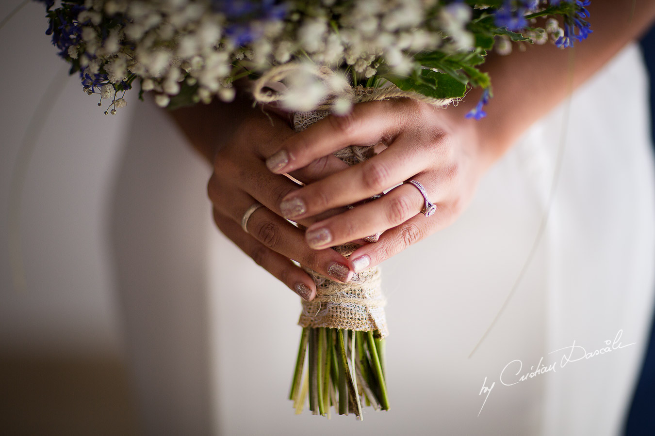 Real moment captured with the bridal bouquet and the engagement ring at a wedding at Minthis Hills in Cyprus, by Cristian Dascalu.