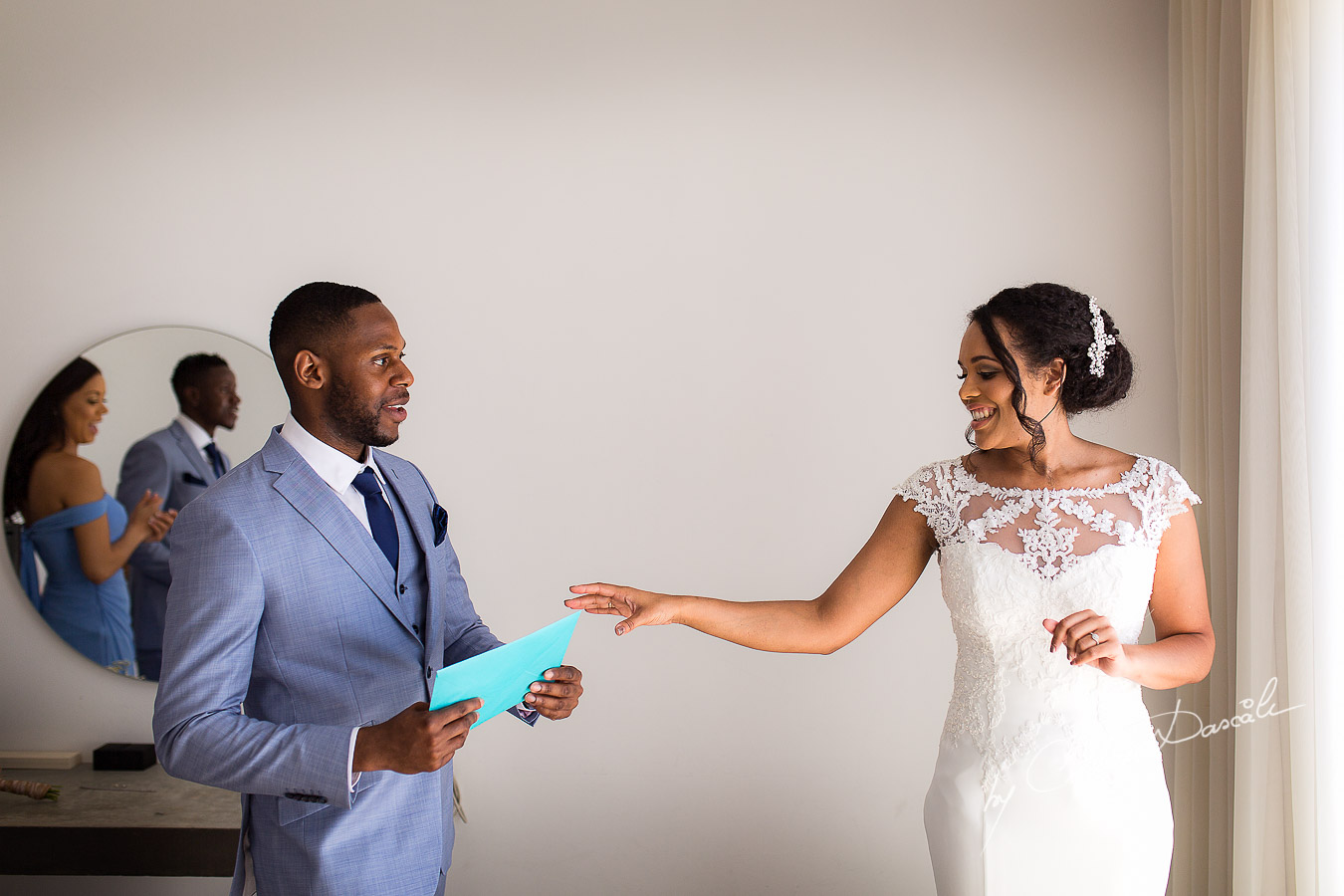 Moments when the best man is delivering a letter to the bride captured at a wedding at Minthis Hills in Cyprus, by Cristian Dascalu.