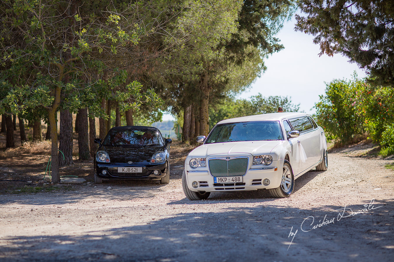 The arrival of the bridal limousine captured at a wedding at Minthis Hills in Cyprus, by Cristian Dascalu.