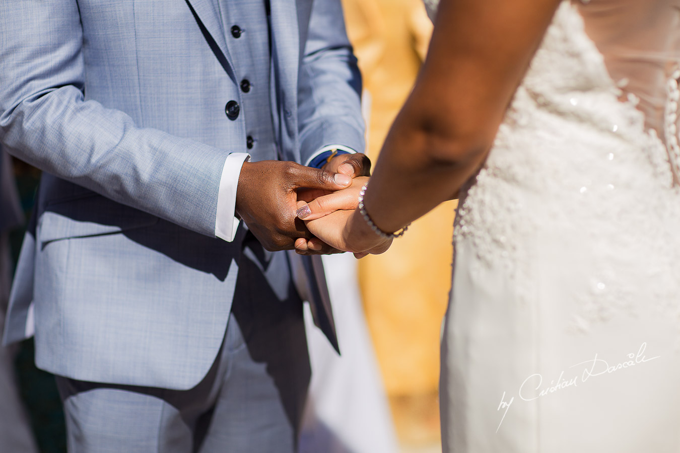Moments and the bride and the groom are holding hands captured at a wedding at Minthis Hills in Cyprus, by Cristian Dascalu.