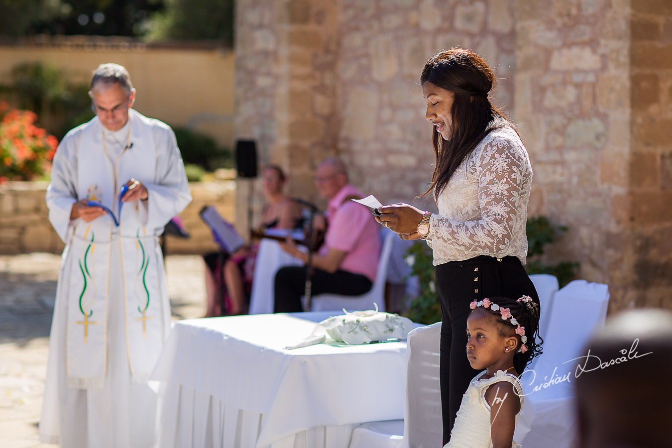 Moments when a guest is reading a poem, captured at Beautiful ceremony moments captured at a wedding at Minthis Hills in Cyprus, by Cristian Dascalu.