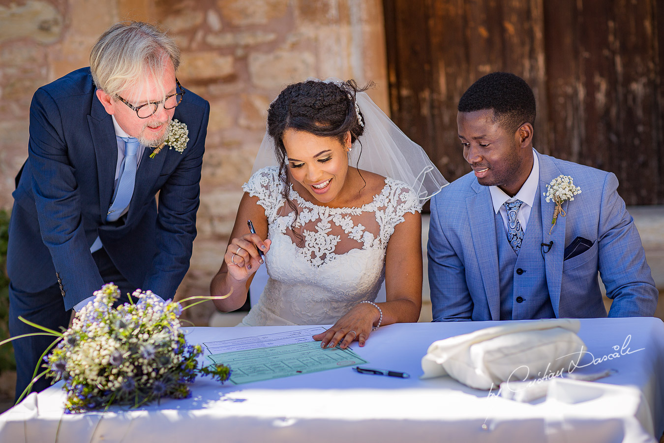 Bride and groom signing their wedding certificates, moments captured at a wedding at Minthis Hills in Cyprus, by Cristian Dascalu.