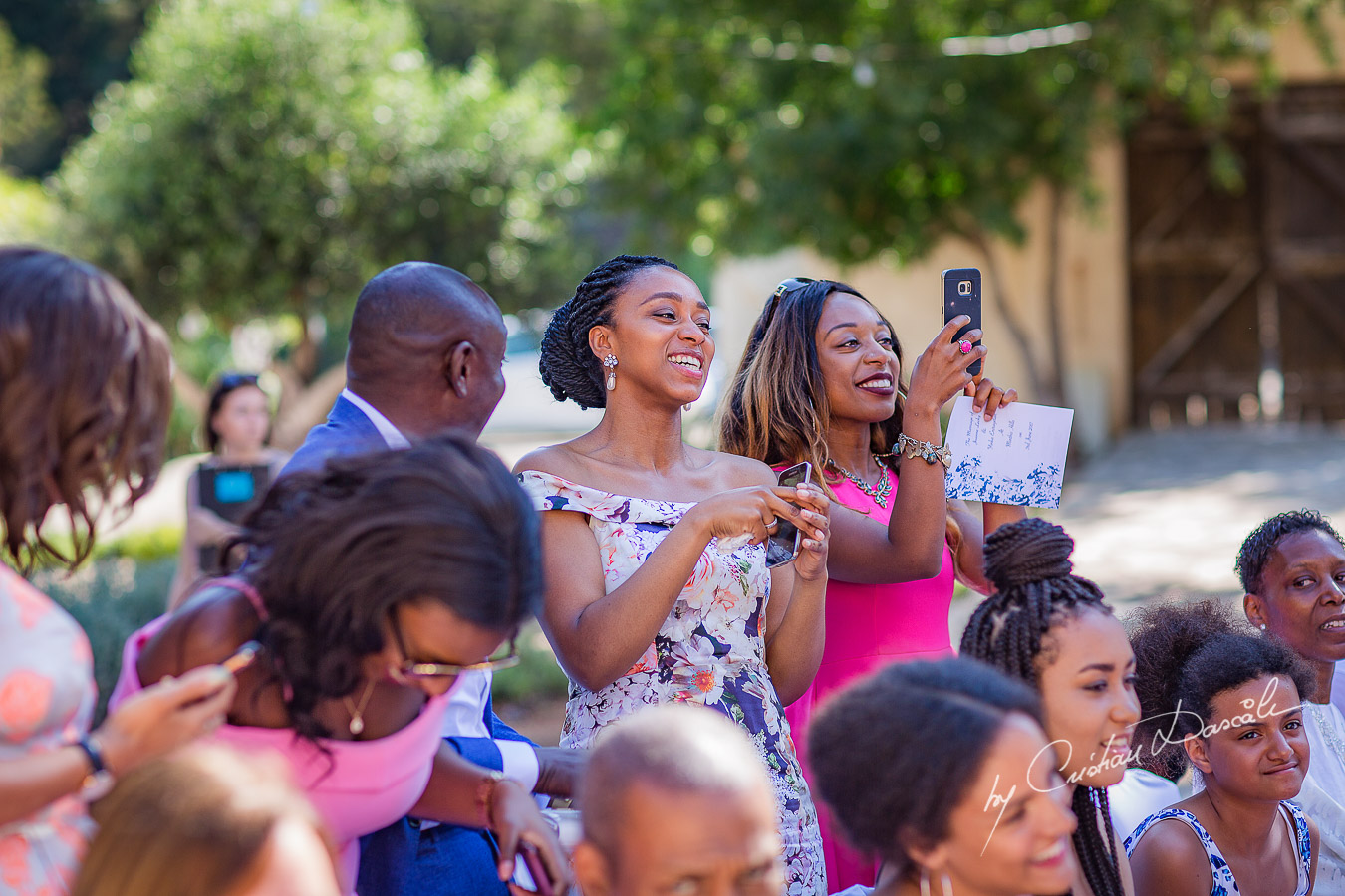 Guests taking photos after the ceremony, moments captured at a wedding at Minthis Hills in Cyprus, by Cristian Dascalu.