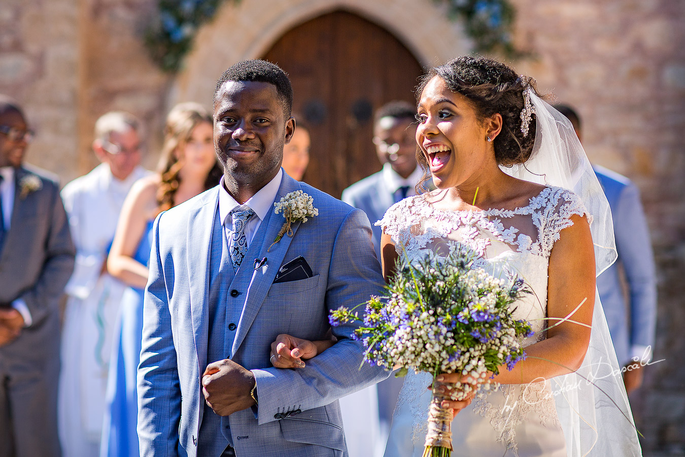 Bride and groom make their way out, moments captured at a wedding at Minthis Hills in Cyprus, by Cristian Dascalu.