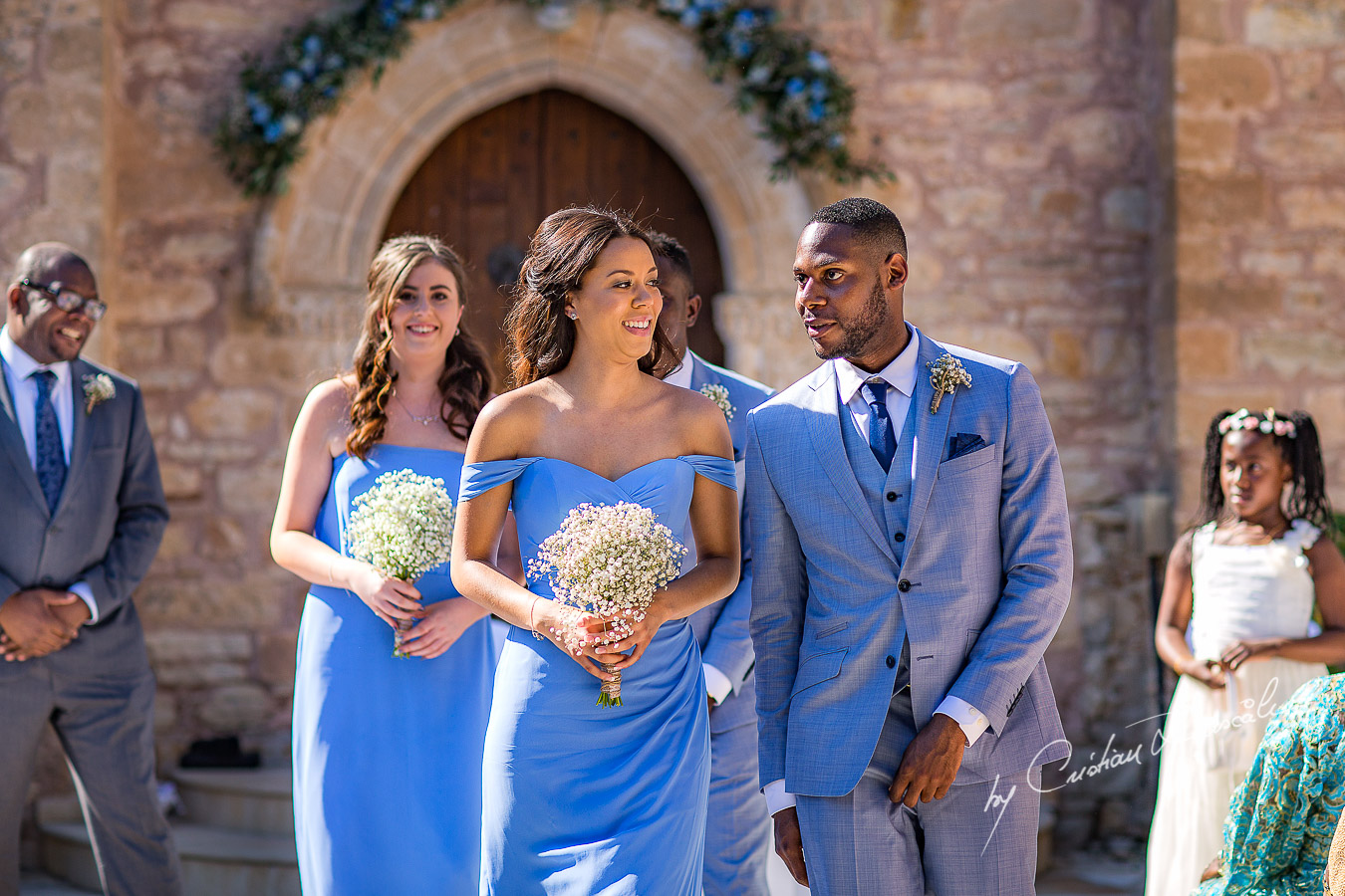 Bridesmaids and Groomsmen follow the bride and groom, moments captured at a wedding at Minthis Hills in Cyprus, by Cristian Dascalu.