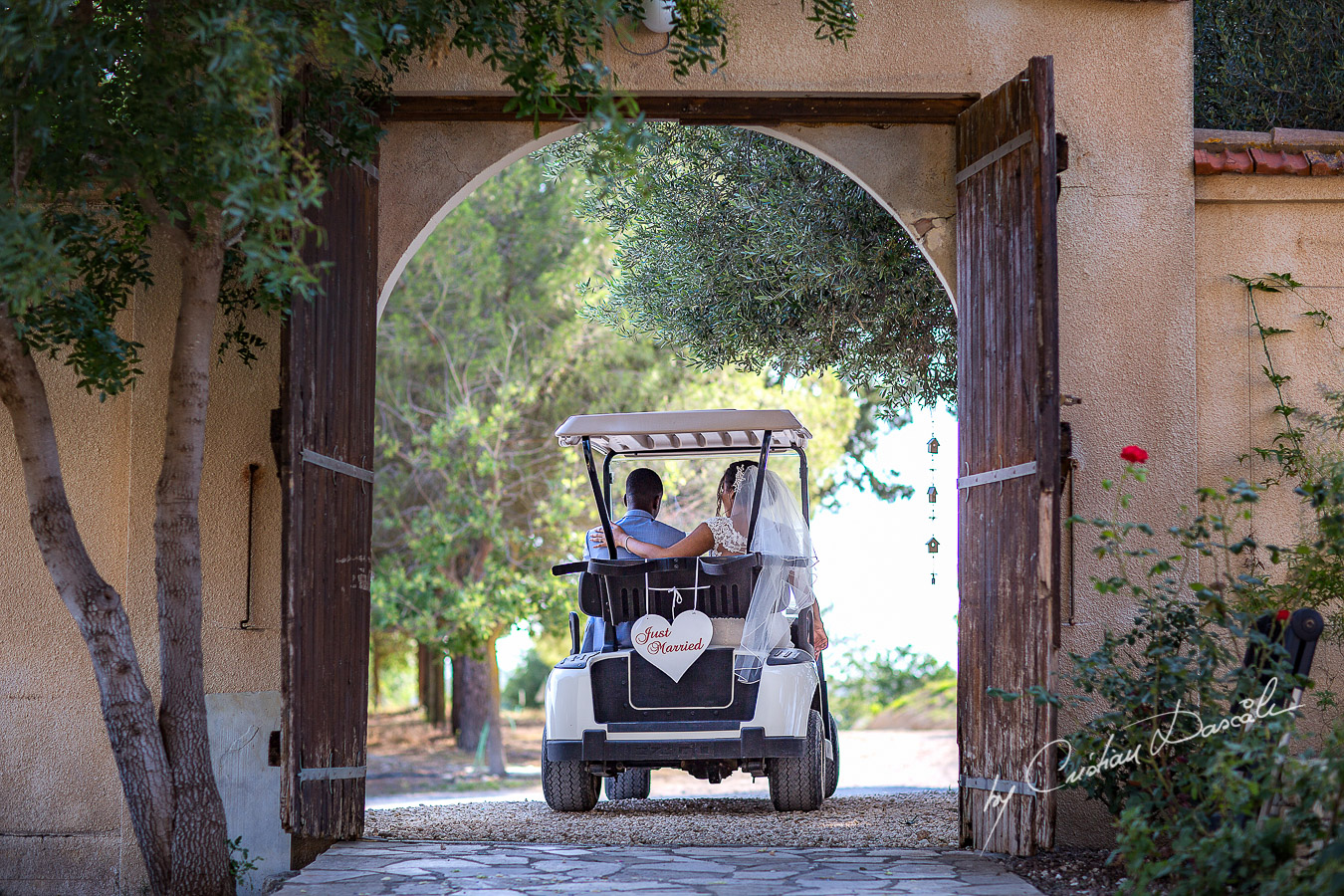 Bride and groom getting away in the bridal bug, moments captured at a wedding at Minthis Hills in Cyprus, by Cristian Dascalu.