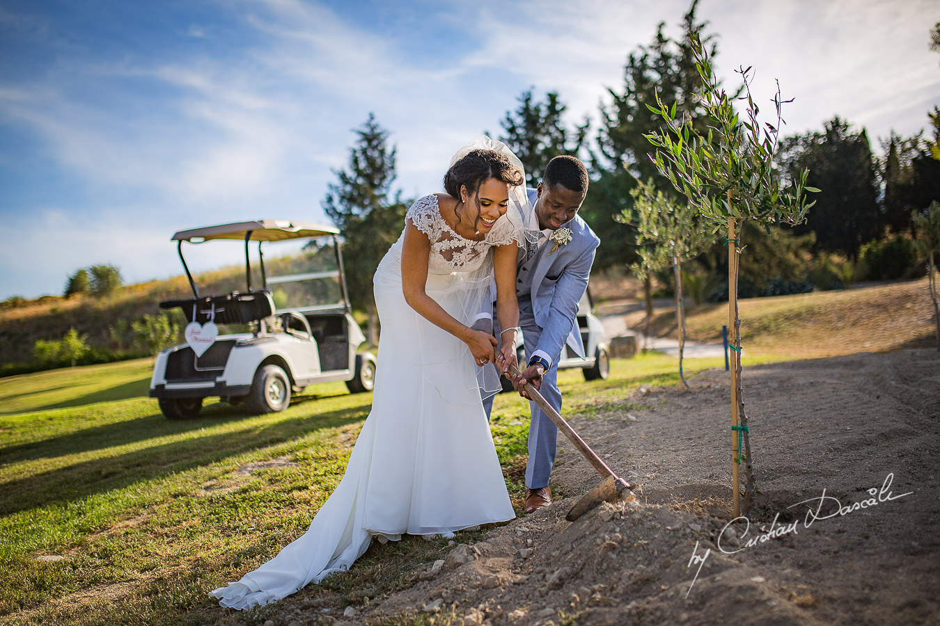 Bride and groom planting an olive tree, moments captured at a wedding at Minthis Hills in Cyprus, by Cristian Dascalu.