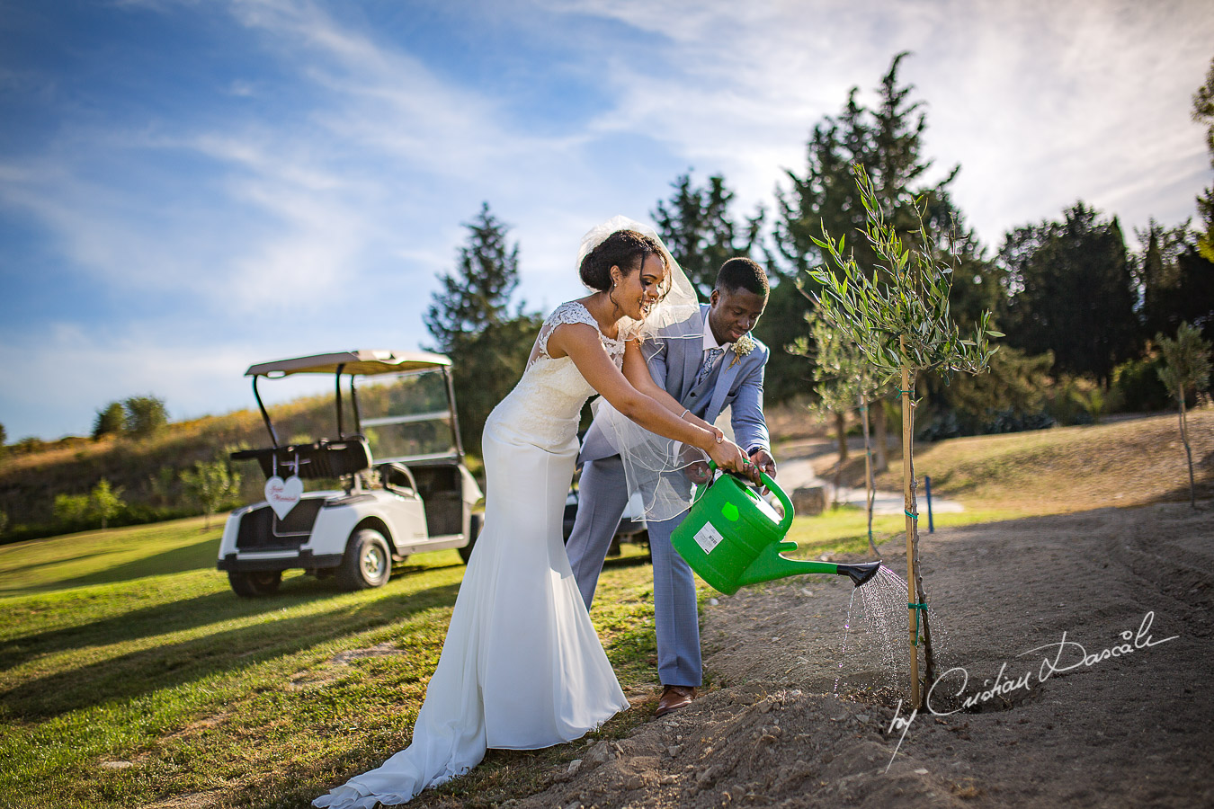 Bride and Groom planting an olive tree, moments captured at a wedding at Minthis Hills in Cyprus, by Cristian Dascalu.