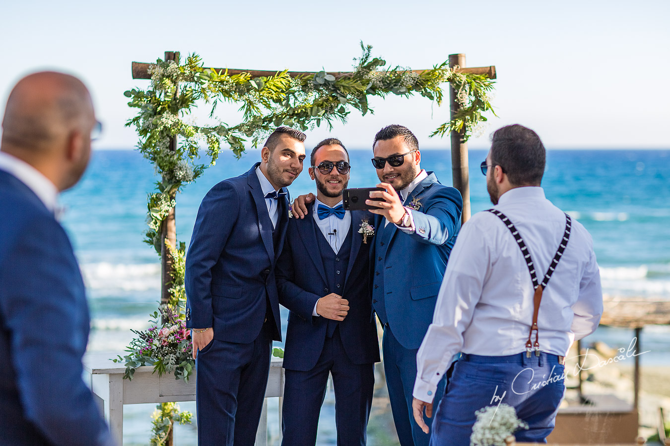 Groom and best men posing for selfies before the reception, as part of an Exclusive Wedding photography at Grand Resort Limassol, captured by Cyprus Wedding Photographer Cristian Dascalu.