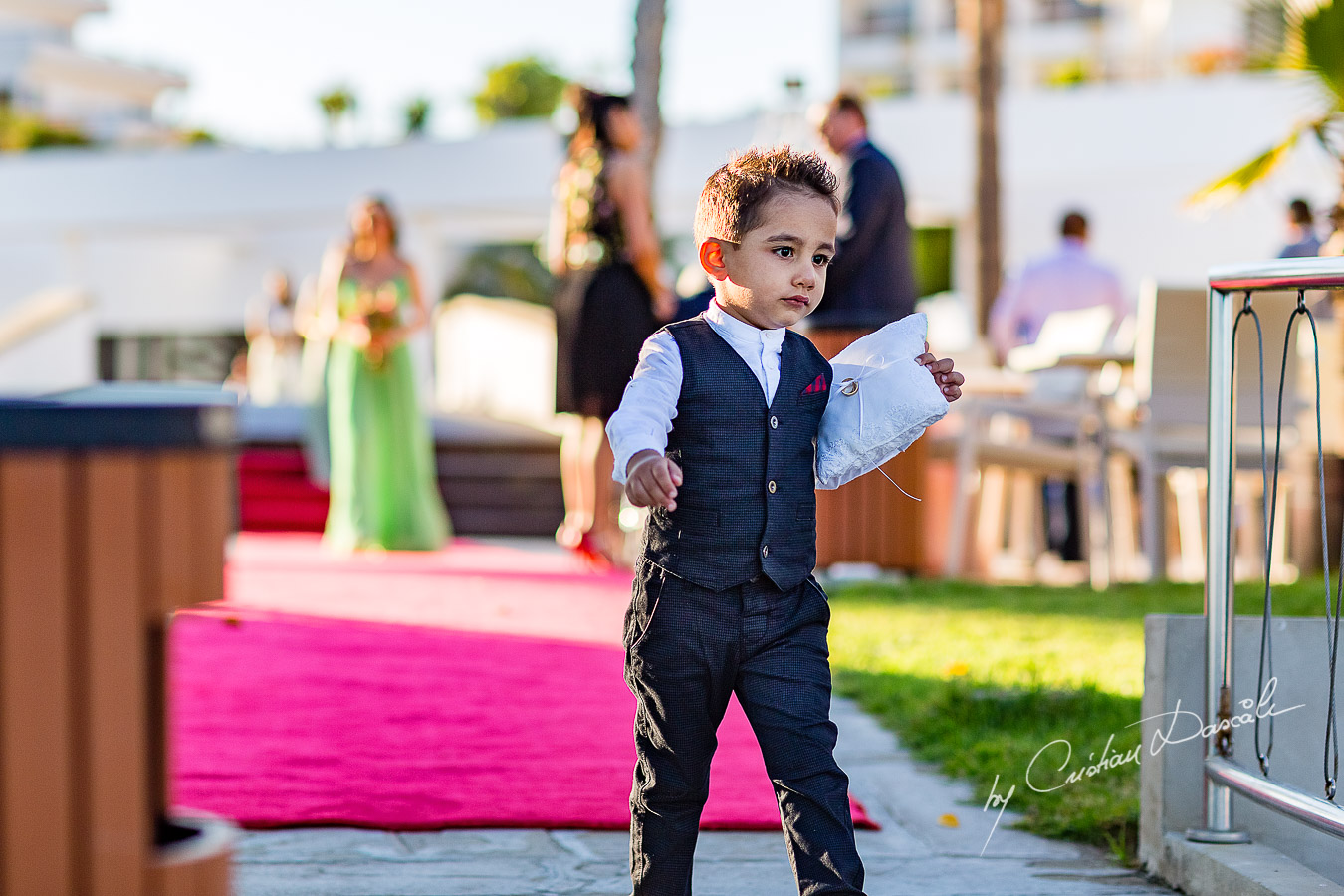 Paige boy photographed during the ceremony, as part of an Exclusive Wedding photography at Grand Resort Limassol, captured by Cyprus Wedding Photographer Cristian Dascalu.