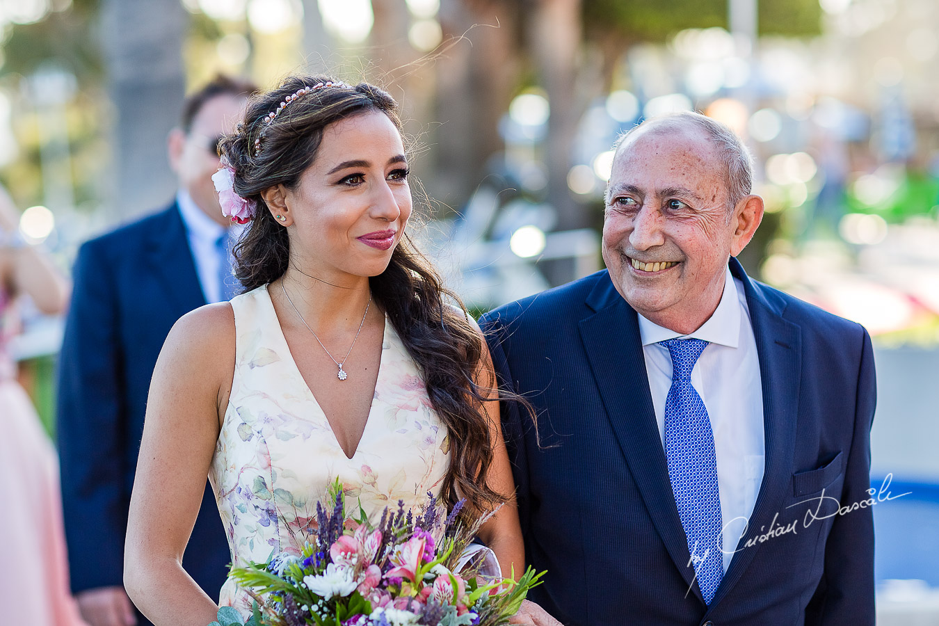 The bride coming down the isle with her father photographed during the ceremony, as part of an Exclusive Wedding photography at Grand Resort Limassol, captured by Cyprus Wedding Photographer Cristian Dascalu.
