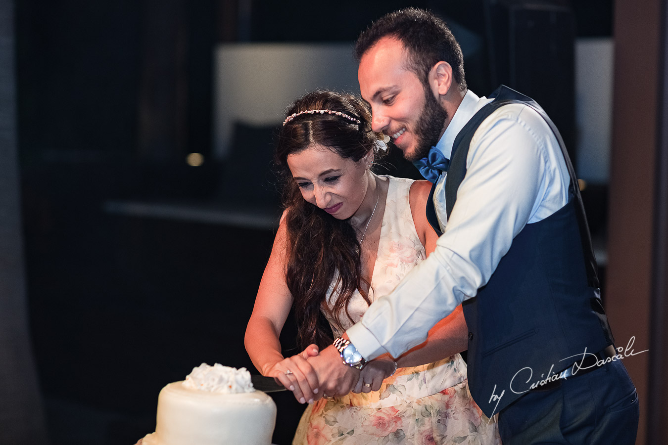 Funny moments when the couple is cutting the cake photographed as part of an Exclusive Wedding photography at Grand Resort Limassol, captured by Cyprus Wedding Photographer Cristian Dascalu.