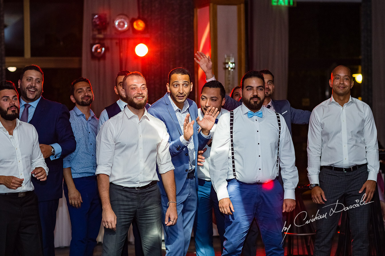 Moment when the groom is throwing the garter photographed as part of an Exclusive Wedding photography at Grand Resort Limassol, captured by Cyprus Wedding Photographer Cristian Dascalu.