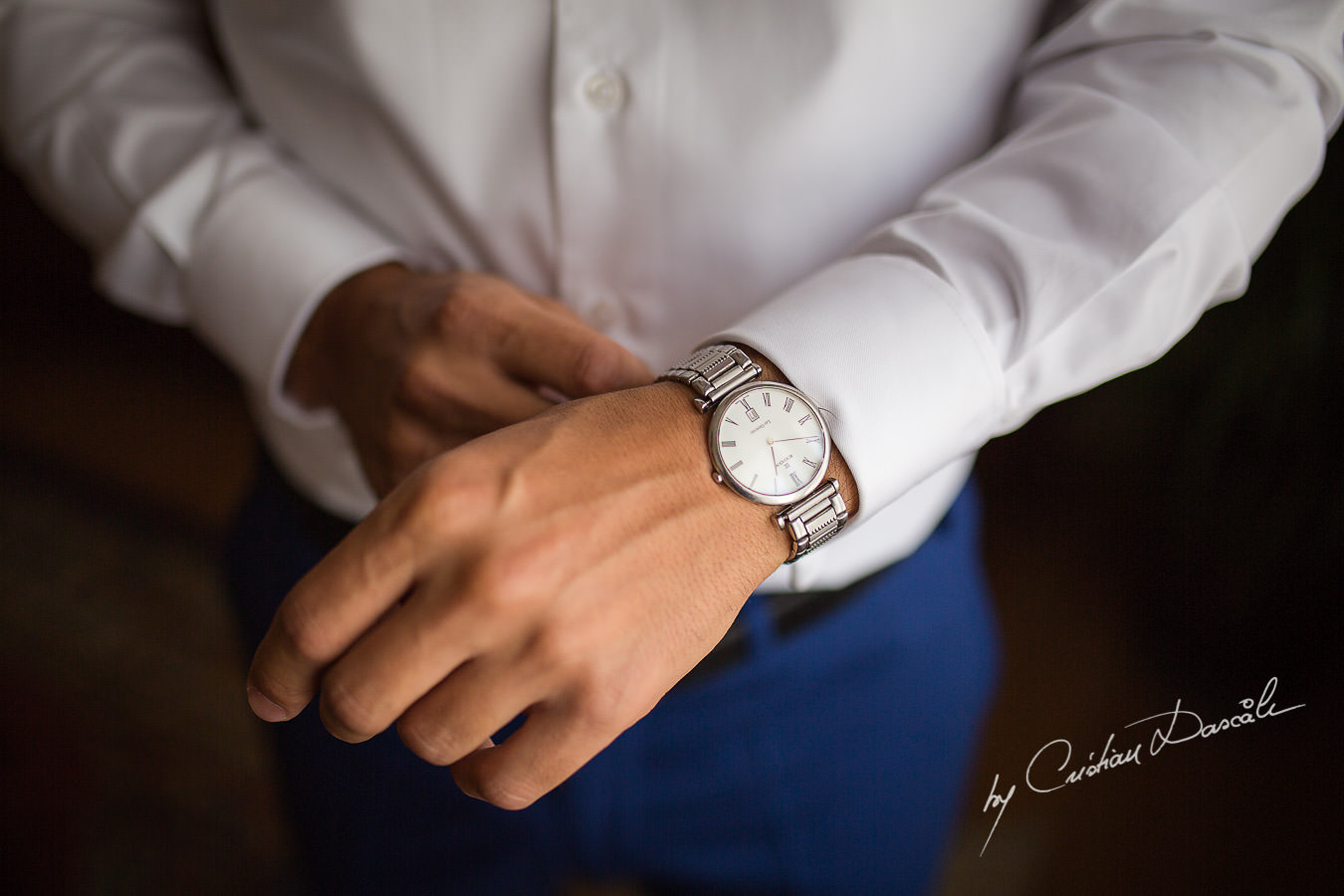 The Groom, Alexis, arranging his Edox watch, captured at a wedding in Cyprus by Photographer Cristian Dascalu.