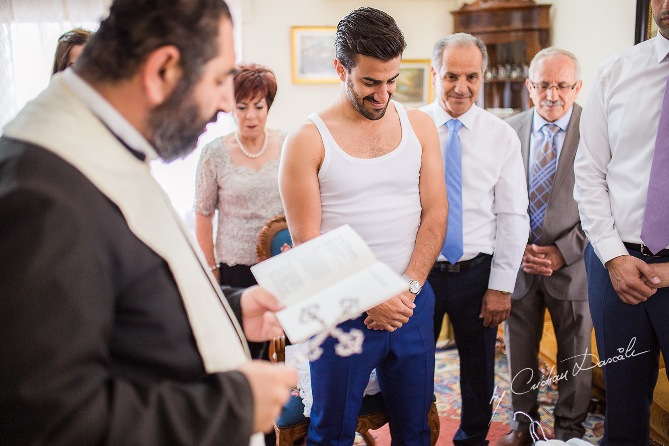 The priest and the groom during a traditional ceremony, captured at a wedding in Cyprus by Photographer Cristian Dascalu.