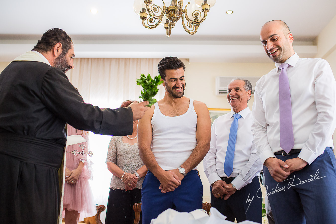 The priest and the groom during a traditional ceremony, captured at a wedding in Cyprus by Photographer Cristian Dascalu.