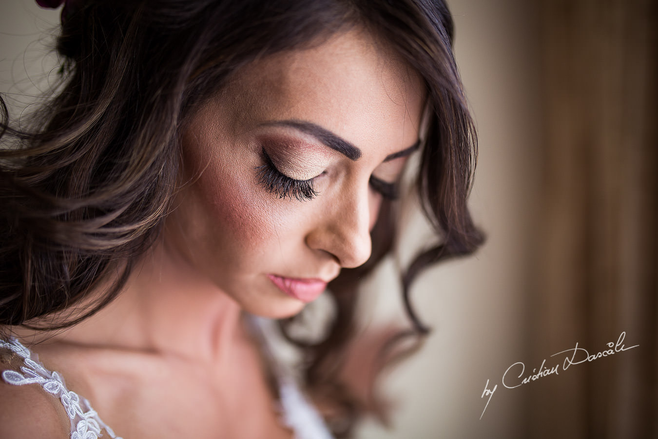 Christiana, the bride, helped by her koumera while getting ready for her wedding ceremony, moments captured at a wedding in Cyprus by Cristian Dascalu Photographer.