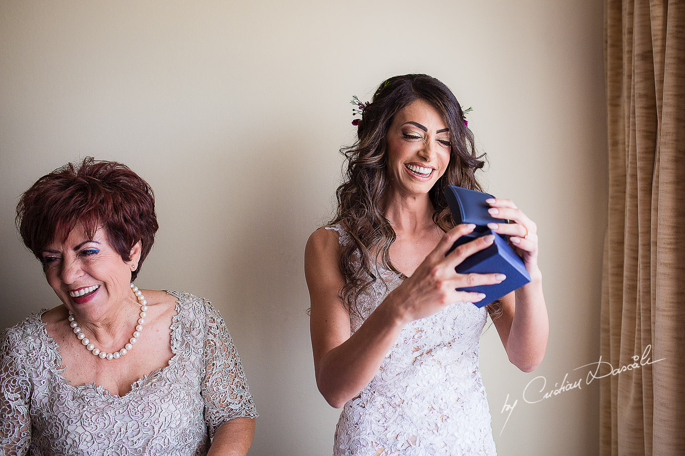 Christiana, the bride, receiving her wedding present from her future husband to be, moments captured at a wedding in Cyprus by Cristian Dascalu Photographer.