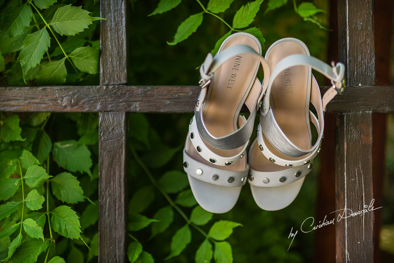 A beautiful wedding day at the Vasilias Nikoklis Inn in Paphos, captured by Cristian Dascalu. Sarah's wedding shoes photographed on Inn's gate.