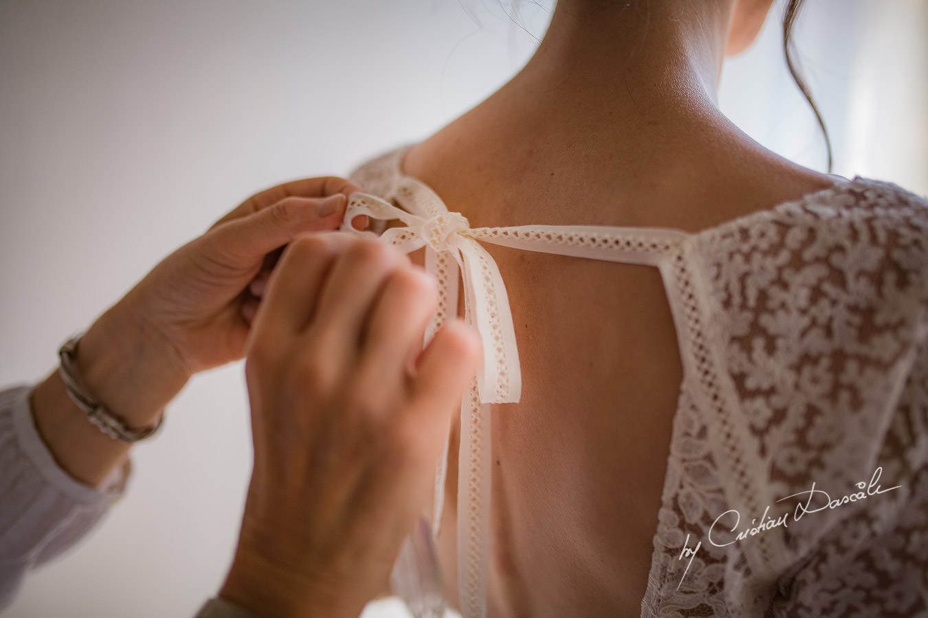 A beautiful wedding day at the Vasilias Nikoklis Inn in Paphos, captured by Cristian Dascalu. Sarah's mother is getting her ready for the wedding ceremony.