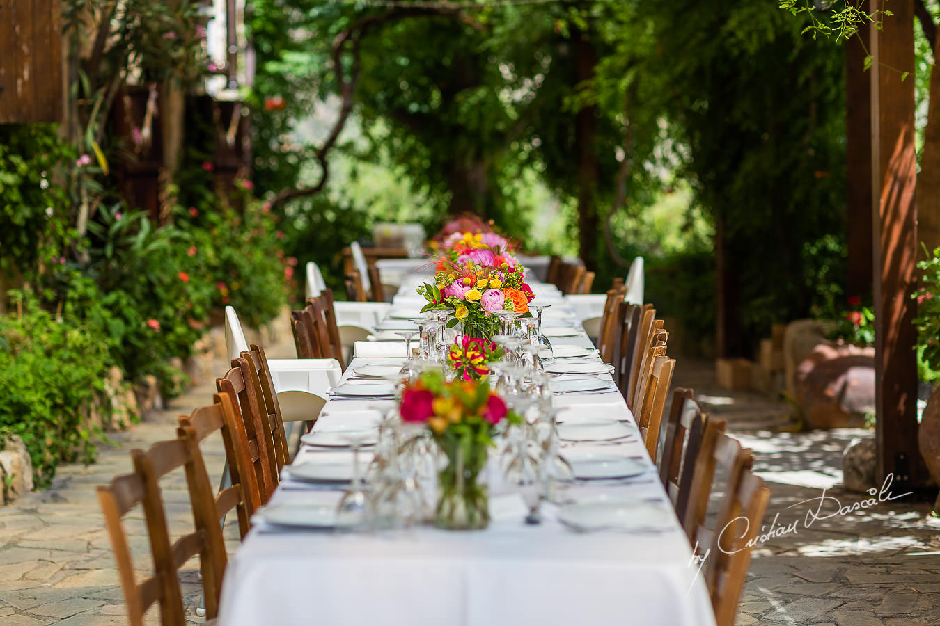 A beautiful wedding day at the Vasilias Nikoklis Inn in Paphos, captured by Cristian Dascalu. The dinner table.