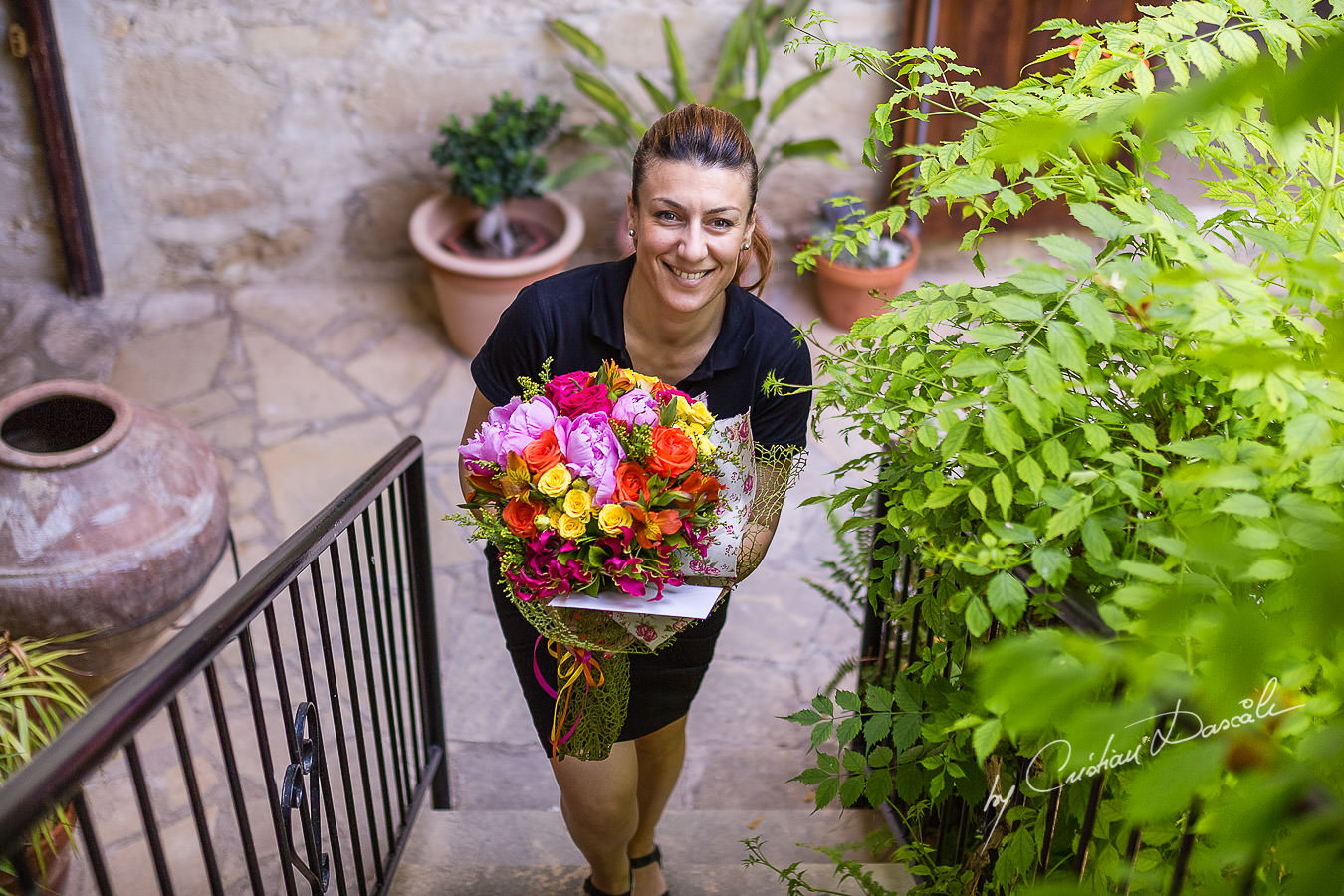 A beautiful wedding day at the Vasilias Nikoklis Inn in Paphos, captured by Cristian Dascalu. Chris, the Inn's owner is bringing the bridal bouquet to Sarah.