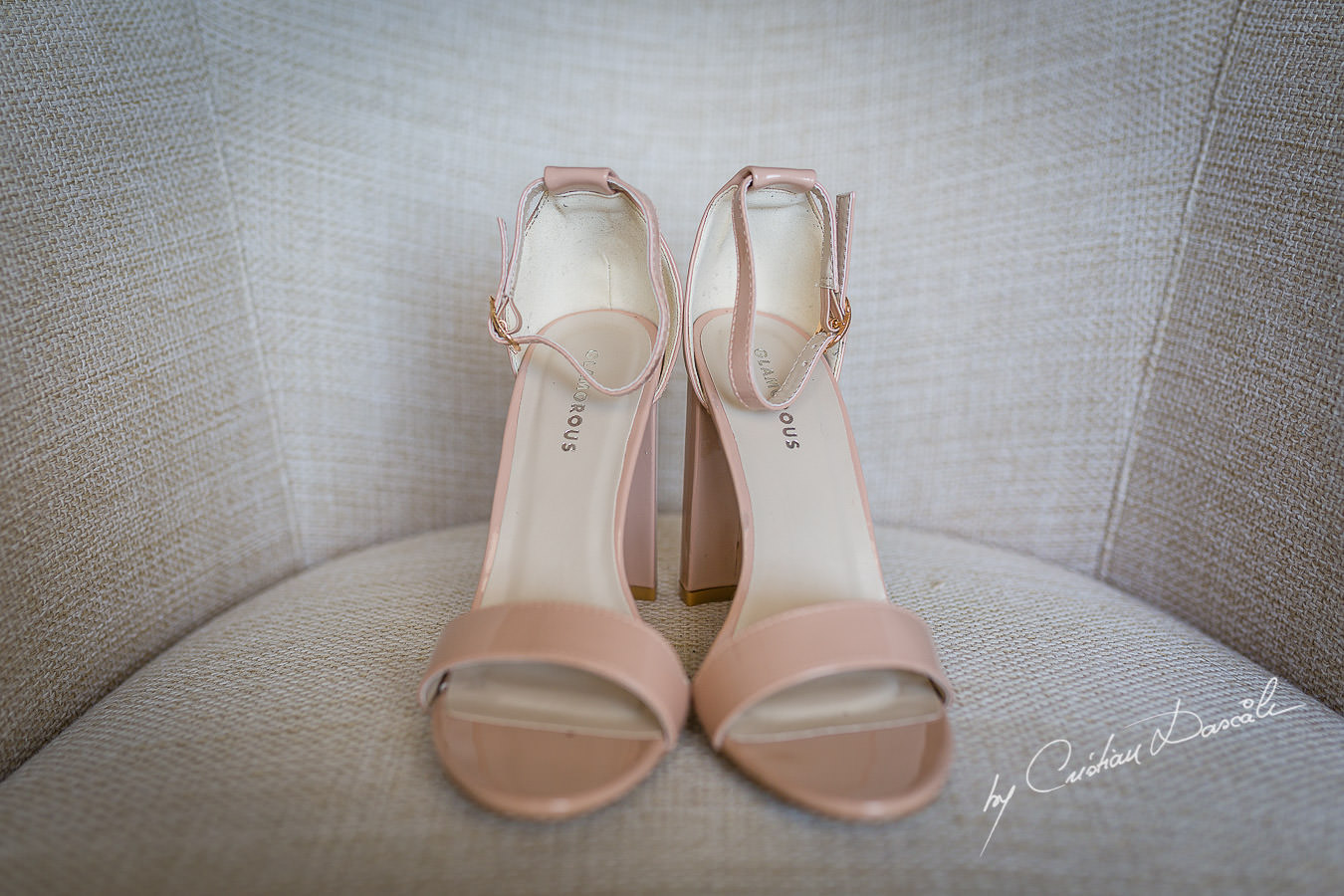 Bride's shoes photographed by Cristian Dascalu at Athena Beach Hotel in Paphos, Cyprus, during a symbolic wedding.