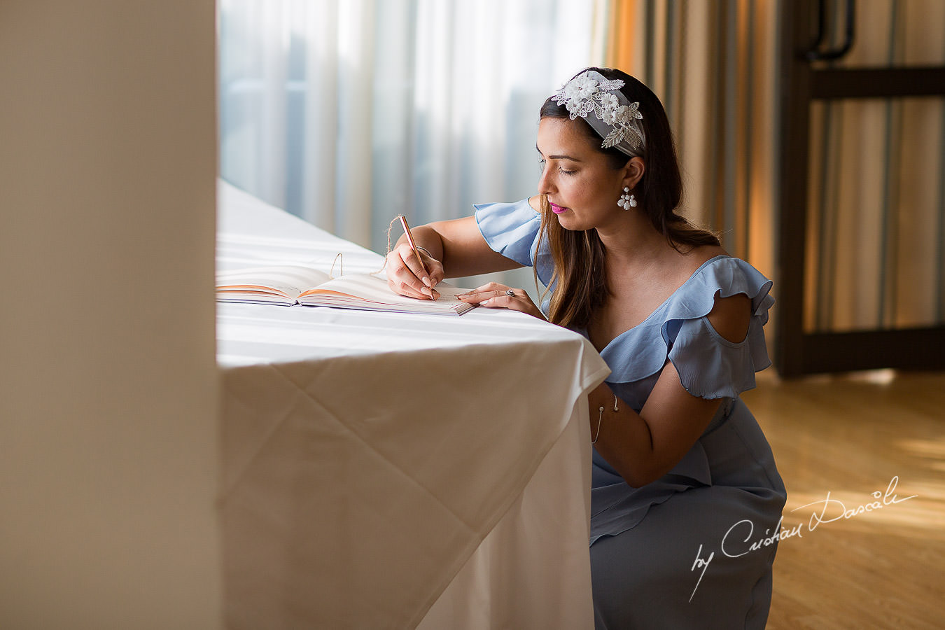 Guests writing wishes int he guest book, moments photographed by Cristian Dascalu at Athena Beach Hotel in Paphos, Cyprus, during a symbolic wedding.