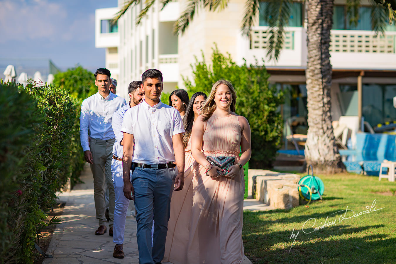 Groomsmen and bridesmaids arriving for the wedding ceremony, moments photographed by Cristian Dascalu at Athena Beach Hotel in Paphos, Cyprus, during a symbolic wedding.