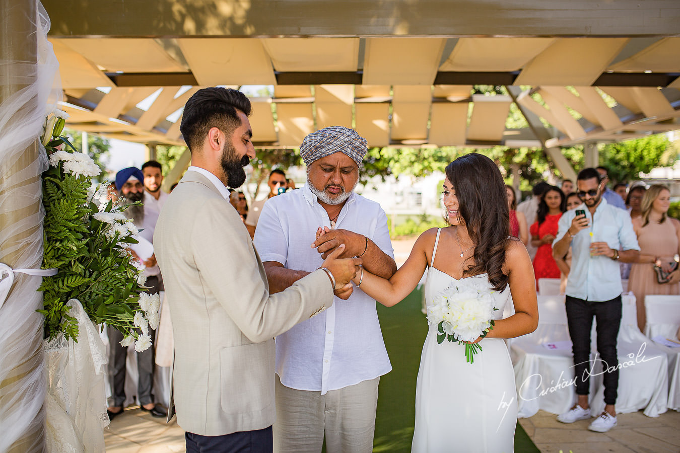 The father of the bride giving his blessings before the wedding ceremony, moments photographed by Cristian Dascalu at Athena Beach Hotel in Paphos, Cyprus, during a symbolic wedding.