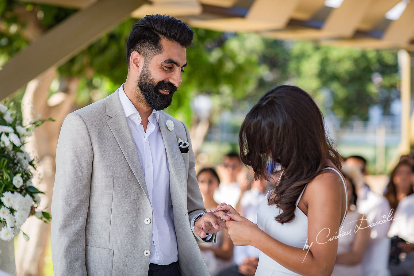 Bride and Groom changing rings, moments photographed by Cristian Dascalu at Athena Beach Hotel in Paphos, Cyprus, during a symbolic wedding.