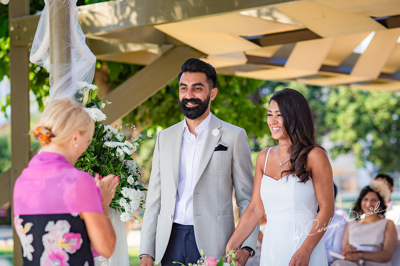 Bride and Groom changing vows, moments photographed by Cristian Dascalu at Athena Beach Hotel in Paphos, Cyprus, during a symbolic wedding.