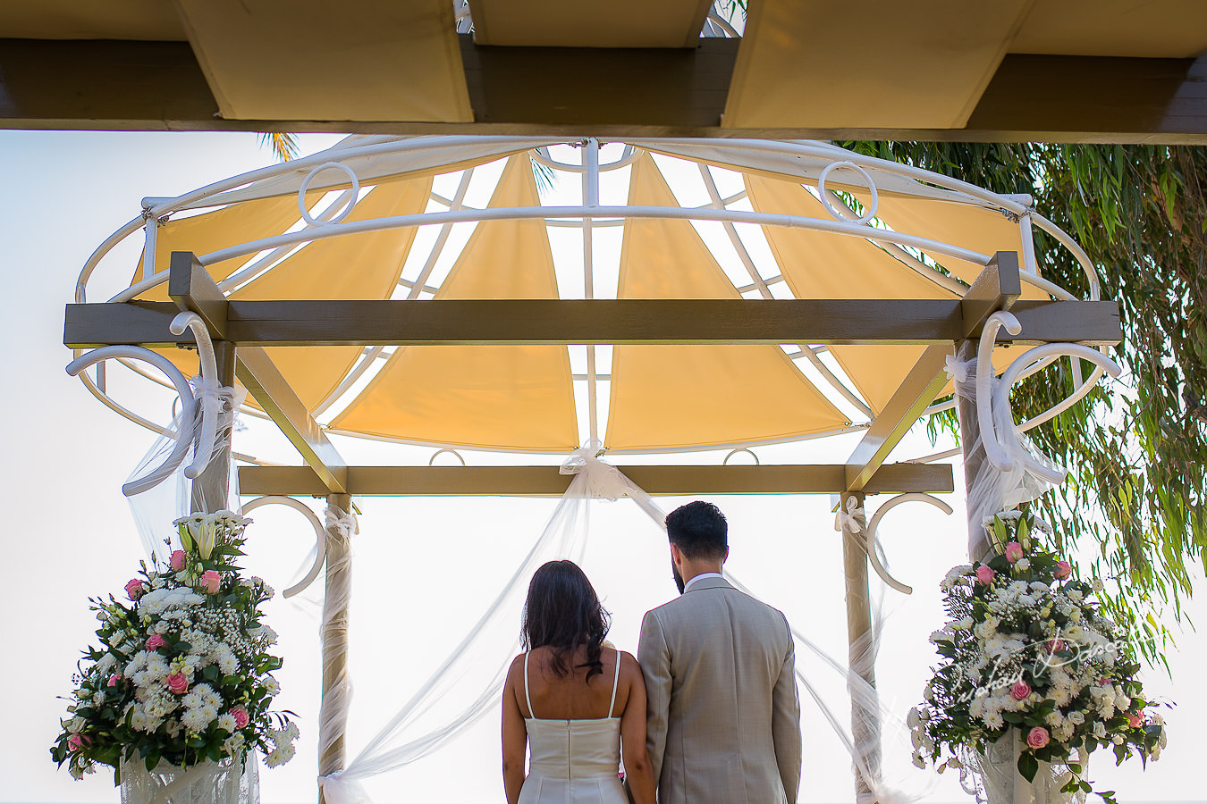 Bride and groom changing vows, moments photographed by Cristian Dascalu at Athena Beach Hotel in Paphos, Cyprus, during a symbolic wedding.