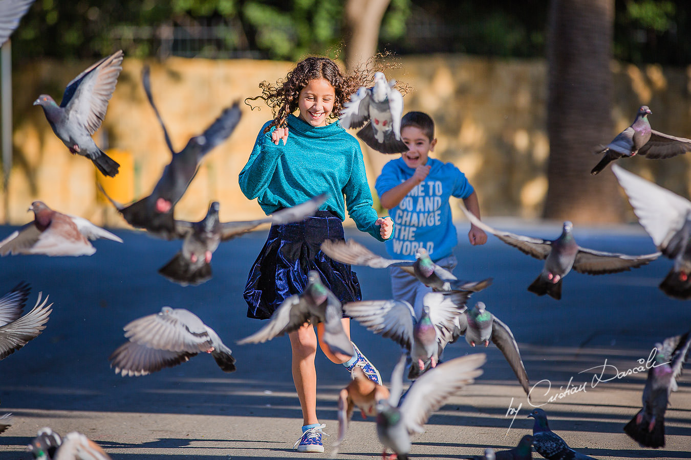 Young brother and sister running through birds, , moments captured by Cristian Dascalu during a beautiful Limassol family photography photo session.